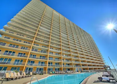 a large building with a swimming pool in front of it at Treasure Island 2005 Beach Front in Panama City Beach