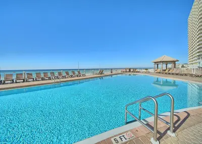 a large swimming pool with the beach in the background at Treasure Island 2005 Beach Front in Panama City Beach