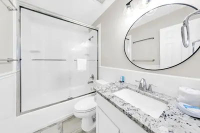 a bathroom with a shower and a sink and a mirror at Cassine Gardens 273- Kwitcherbeachin' in Santa Rosa Beach