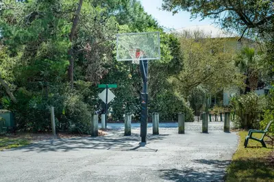 a basketball hoop in a park with a bench at Cassine Gardens 273- Kwitcherbeachin' in Santa Rosa Beach