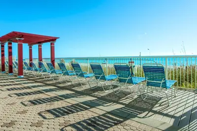 a row of chairs sitting on the beach at Majestic Beach Towers 1-1804 in Panama City Beach