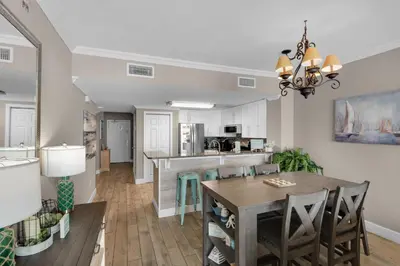 a dining room and kitchen with a table and chairs at Majestic Beach Towers 1-1804 in Panama City Beach