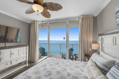 a bedroom with a bed and a view of the ocean at Majestic Beach Towers 1-1804 in Panama City Beach