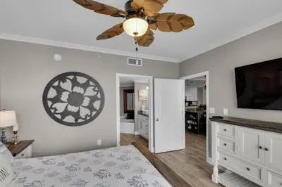 a bedroom with a bed and a ceiling fan at Majestic Beach Towers 1-1804 in Panama City Beach