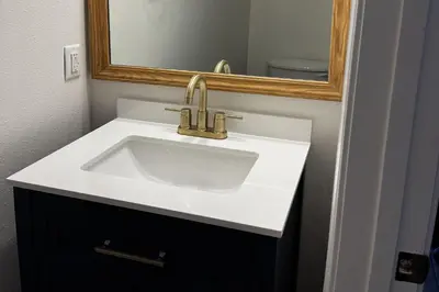 a bathroom with a white sink and a mirror at Bonita Point Condo II #214E in Panama City Beach