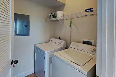 a small laundry room with a washer and dryer at Bonita Point Condo II #214E in Panama City Beach