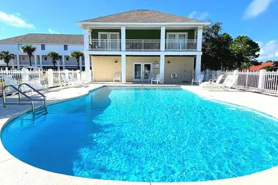 a large blue swimming pool in front of a house at Bonita Point Condo II #214E in Panama City Beach