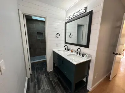 a bathroom with a sink and a mirror at Beautiful House Sleeps 12 - Hot Tub - Breakfast - Walk to Beach in Panama City Beach