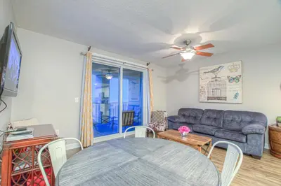 a living room with a couch and a table at Grand Panama 2-307 in Panama City Beach