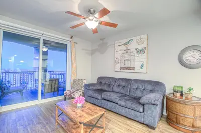 a living room with a couch and a ceiling fan at Grand Panama 2-307 in Panama City Beach