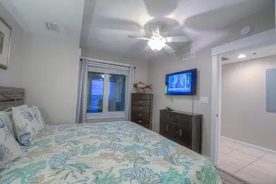 a bedroom with a bed and a ceiling fan at Grand Panama 2-307 in Panama City Beach