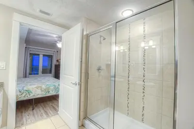 a bathroom with a shower and a glass shower stall at Grand Panama 2-307 in Panama City Beach