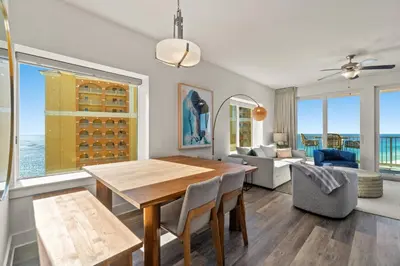 a dining room with a table and chairs and a living room at New Calypso Beach Resort Corner Unit Sleeps 8! by Dolce Vita Getaways PCB in Panama City Beach