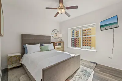 a bedroom with a bed and a ceiling fan at New Calypso Beach Resort Corner Unit Sleeps 8! by Dolce Vita Getaways PCB in Panama City Beach