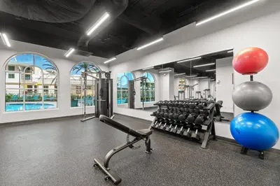a gym with dumbbells and balloons in a room at New Calypso Beach Resort Corner Unit Sleeps 8! by Dolce Vita Getaways PCB in Panama City Beach