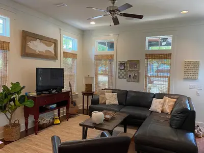 a living room with a couch and a flat screen tv at The Summer Palace in Inlet Beach