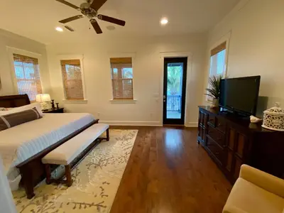 a bedroom with a bed and a flat screen tv at The Summer Palace in Inlet Beach