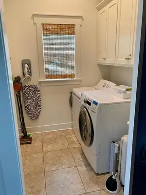 a laundry room with a washing machine and a window at The Summer Palace in Inlet Beach