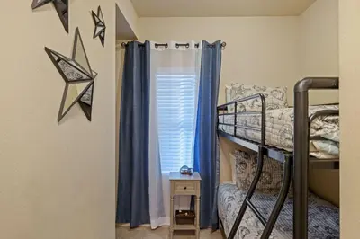 a bedroom with a bunk bed and a window at Stunning Resort Low Floor Condo! Sleeps 8! Steps 2 Beach & Restaurants! by Dolce Vita Getaways PCB in Panama City Beach