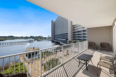 a balcony with a view of a river and a building at Stunning Resort Low Floor Condo! Sleeps 8! Steps 2 Beach & Restaurants! by Dolce Vita Getaways PCB in Panama City Beach