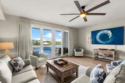 a living room with a couch and a ceiling fan at Stunning Views! located Steps 2 Beach, Restaurants & Shops! by Dolce Vita Getaways PCB in Panama City Beach