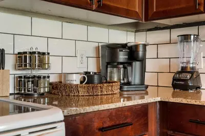 a kitchen counter top with a coffee maker on it at Stunning Views! located Steps 2 Beach, Restaurants & Shops! by Dolce Vita Getaways PCB in Panama City Beach