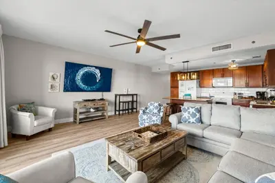 a living room with a couch and a table at Stunning Views! located Steps 2 Beach, Restaurants & Shops! by Dolce Vita Getaways PCB in Panama City Beach