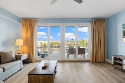a living room with a couch and a table at Lovely Resort Low Floor Condo! Just Steps to the Beach & Restaurants! by Dolce Vita Getaways PCB in Panama City Beach