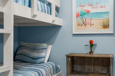 a bedroom with a bunk bed and a desk at Lovely Resort Low Floor Condo! Just Steps to the Beach & Restaurants! by Dolce Vita Getaways PCB in Panama City Beach
