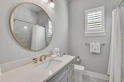 a white bathroom with a sink and a mirror at 30A Pet Friendly Beach House - Seacrest Serenity by Panhandle Getaways in Inlet Beach