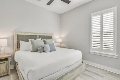 a white bedroom with a bed and a window at 30A Pet Friendly Beach House - Seacrest Serenity by Panhandle Getaways in Inlet Beach