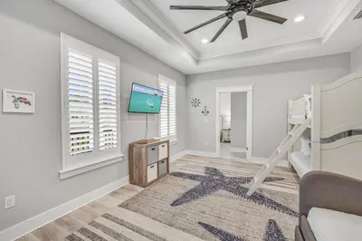 a bedroom with a bed and a ceiling fan at 30A Pet Friendly Beach House - Seacrest Serenity by Panhandle Getaways in Inlet Beach