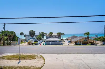 an empty street in front of a house with the ocean at Vista del Mar I BEST Day 202 in Panama City Beach