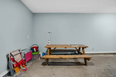 a picnic table in a room with a white wall at Vista del Mar I BEST Day 202 in Panama City Beach