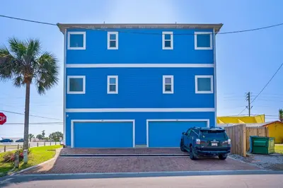 a blue house with a car parked in front of it at Vista del Mar I BEST Day 202 in Panama City Beach
