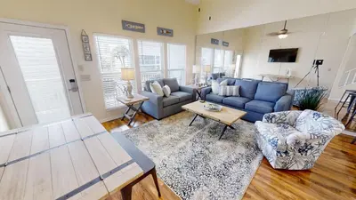 a living room with a blue couch and a table at Southwind Condominiums 6-B in Panama City Beach