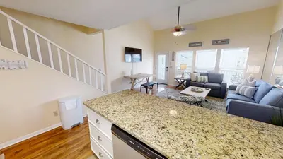 a kitchen and living room with a couch and a table at Southwind Condominiums 6-B in Panama City Beach