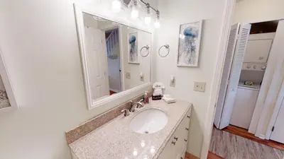 a white bathroom with a sink and a mirror at Southwind Condominiums 6-B in Panama City Beach