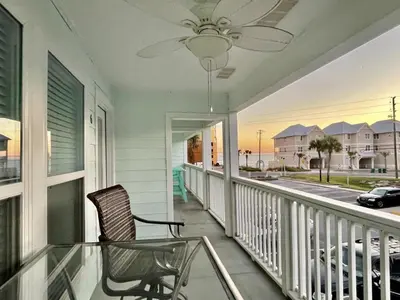 a chair on a balcony with a view of the ocean at Southwind Condominiums 6-B in Panama City Beach