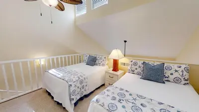 a bedroom with two beds in a attic at Southwind Condominiums 6-B in Panama City Beach
