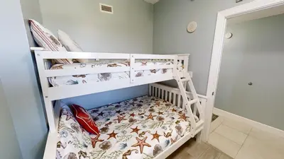 a bedroom with two bunk beds in a room at Sunrise Beach 1408 in Panama City Beach