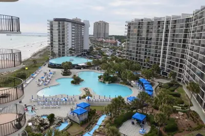 an aerial view of a resort with a pool and the beach at Gulf front condo in Panama City Beach