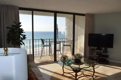 a living room with a view of the ocean at Gulf front condo in Panama City Beach