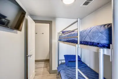 a bedroom with two bunk beds in a room at Shores of Panama 2003 - Renovated 2 bedroom, with Bunkroom Sleeps 6 with a Reserved Parking Space! condo in Panama City Beach
