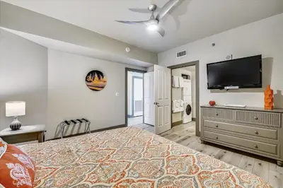 a bedroom with a bed and a flat screen tv at Shores of Panama 2003 - Renovated 2 bedroom, with Bunkroom Sleeps 6 with a Reserved Parking Space! condo in Panama City Beach