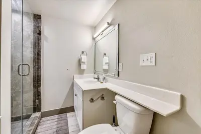 a bathroom with a toilet and a sink and a mirror at Shores of Panama 2003 - Renovated 2 bedroom, with Bunkroom Sleeps 6 with a Reserved Parking Space! condo in Panama City Beach