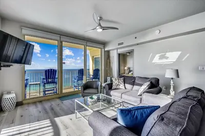a living room with a couch and a view of the ocean at Shores of Panama 2003 - Renovated 2 bedroom, with Bunkroom Sleeps 6 with a Reserved Parking Space! condo in Panama City Beach
