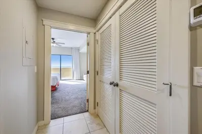 a hallway with a door leading to a bedroom at Origin at Seahaven 403 - Spacious 3 Bedroom withSunset View! Free Fun! condo in Panama City Beach