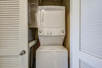 a washer and dryer sitting on top of a toilet at Origin at Seahaven 403 - Spacious 3 Bedroom withSunset View! Free Fun! condo in Panama City Beach