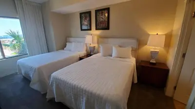 a hotel room with two beds and a window at Origin at Seahaven 403 - Spacious 3 Bedroom withSunset View! Free Fun! condo in Panama City Beach